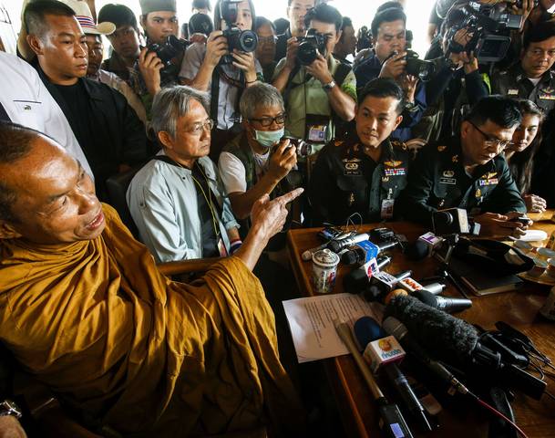Thai buddhist monk and co-protest leader Luang Pu Buddha Isara gestures as he talks with government officials during a negotiations in Bangkok